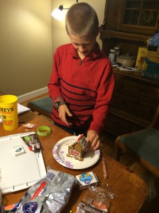 Here is Noah decorating his gingerbread house.